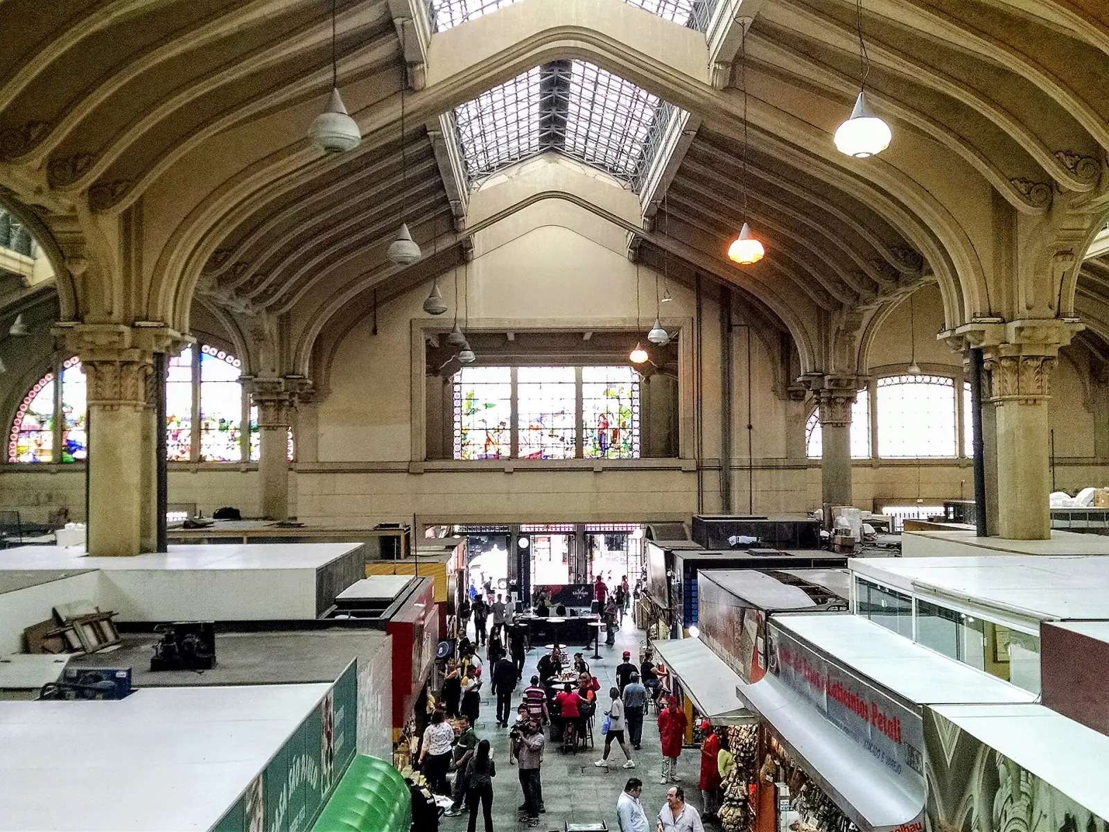 Inside the Mercado Municipal in São Paulo, produce stalls under stained-glass windows