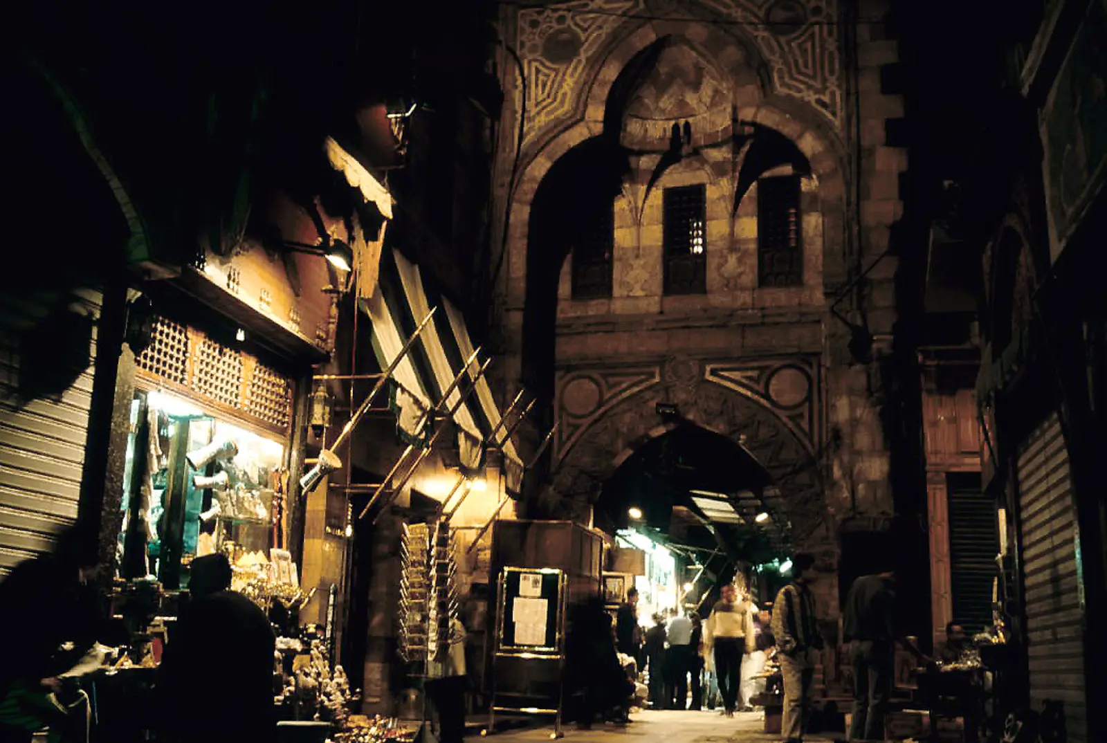 A lane in the Khan el-Khalili bazaar in Cairo, shopfronts crowded with lamps and wares