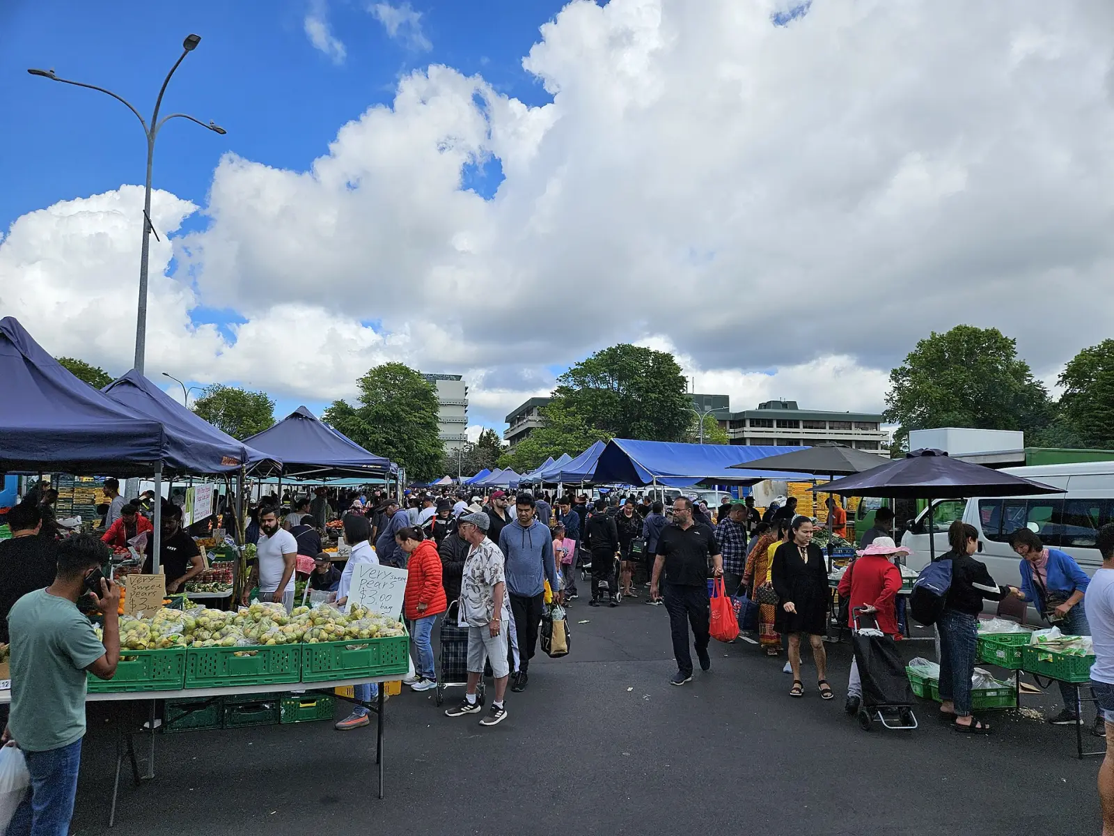 Produce stalls and shoppers at the Ōtara Markets in South Auckland