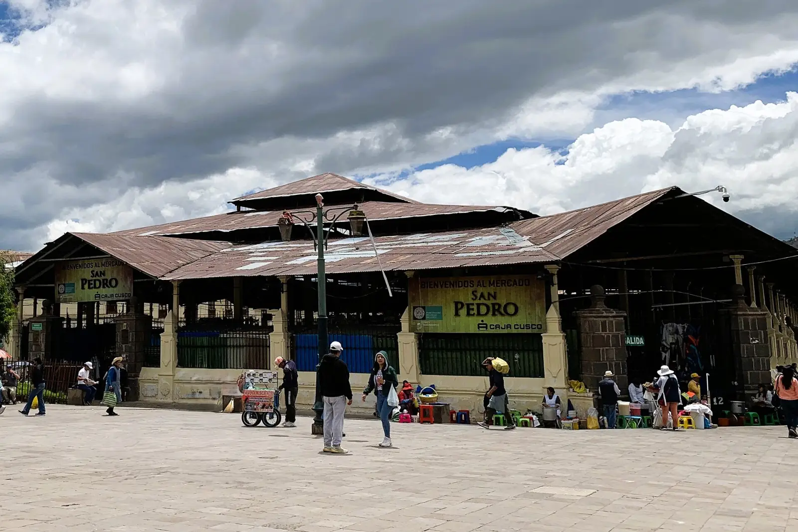 Produce stalls under the iron roof of San Pedro market in Cusco